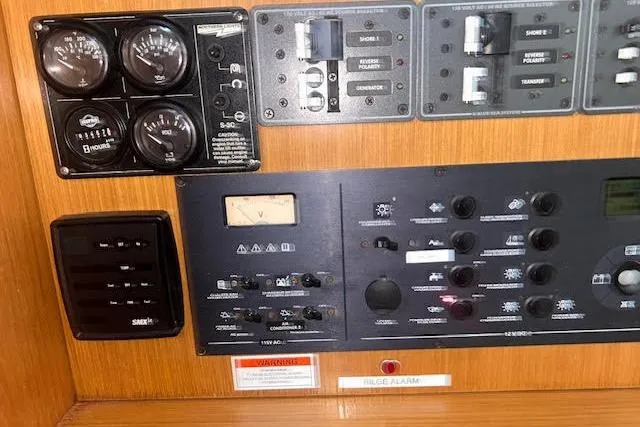 Slide: The Image of Control panel of 2007 Jeanneau Sun Odyssey 42 DS sailboat, featuring gauges and switches. - 24