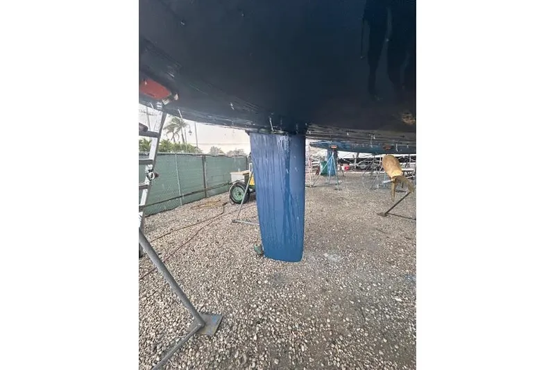 Slide: The Image of 2007 Jeanneau Sun Odyssey 42 DS sailboat keel on dry dock, gravel ground. - 29