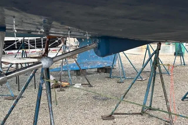 Slide: The Image of 2007 Jeanneau Sun Odyssey 42 DS sailboat on stands, showing hull and propeller shaft. - 30