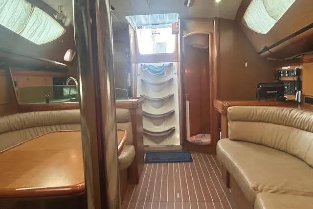 Slide: The Image of Interior of 2007 Jeanneau Sun Odyssey 42 DS yacht with elegant wood finish and seating. - 4