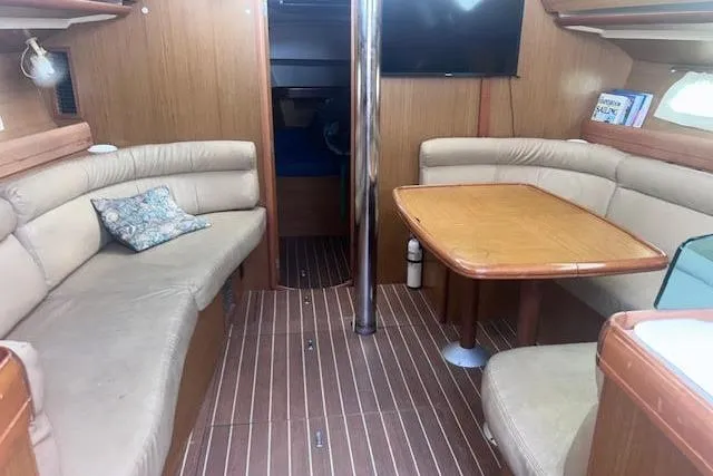 Slide: The Image of Interior of 2007 Jeanneau Sun Odyssey 42 DS yacht with cozy seating and wooden table. - 42