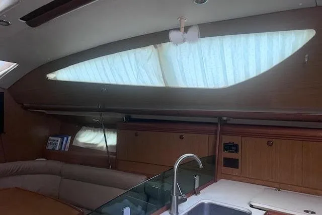 Slide: The Image of Interior of 2007 Jeanneau Sun Odyssey 42 DS yacht, featuring a modern kitchen and seating area. - 44