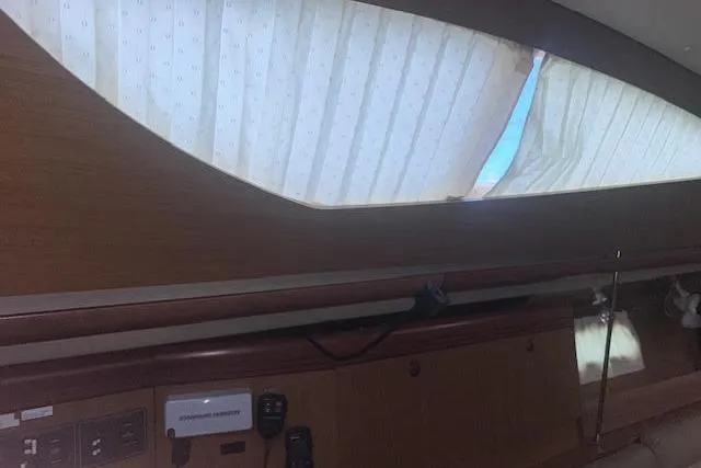 Slide: The Image of Interior view of 2007 Jeanneau Sun Odyssey 42 DS sailboat with wooden paneling and window. - 46