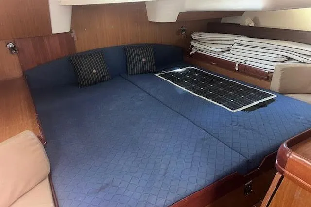 Slide: The Image of Luxurious cabin interior of 2007 Jeanneau Sun Odyssey 42 DS sailboat with blue bedding. - 47
