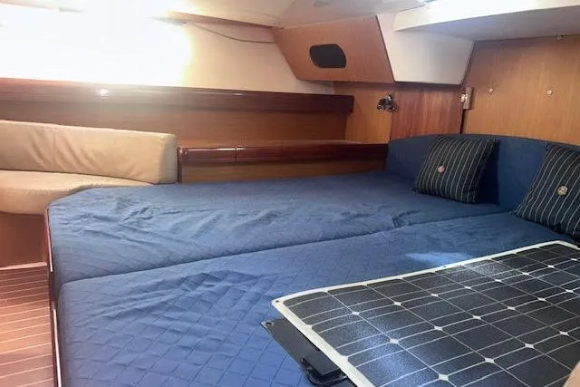 Slide: The Image of Cozy cabin interior of 2007 Jeanneau Sun Odyssey 42 DS with blue bedding and wood accents. - 48