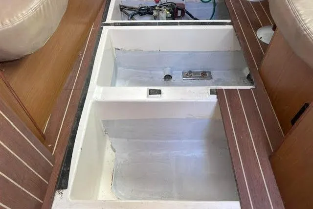 Slide: The Image of Bilge compartment of 2007 Jeanneau Sun Odyssey 42 DS sailboat, showcasing storage and mechanical components. - 54