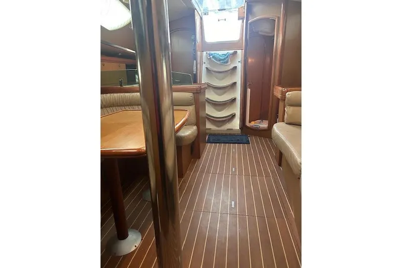 Slide: The Image of Interior of 2007 Jeanneau Sun Odyssey 42 DS sailboat with wood finish and seating area. - 8