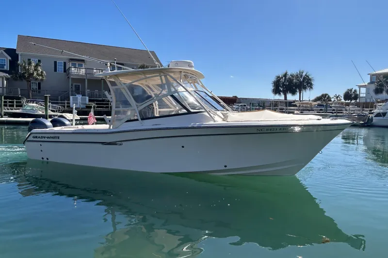 Slide: The Image of 2015 Grady-White Freedom 275 boat docked in a sunny marina. - 1