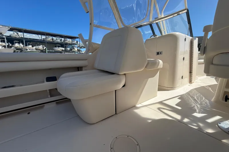 Slide: The Image of 2015 Grady-White Freedom 275 boat interior with seating and clear canopy. - 12