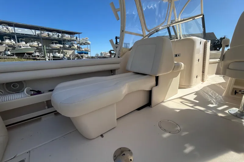 Slide: The Image of 2015 Grady-White Freedom 275 boat interior with white seating and clear canopy. - 13