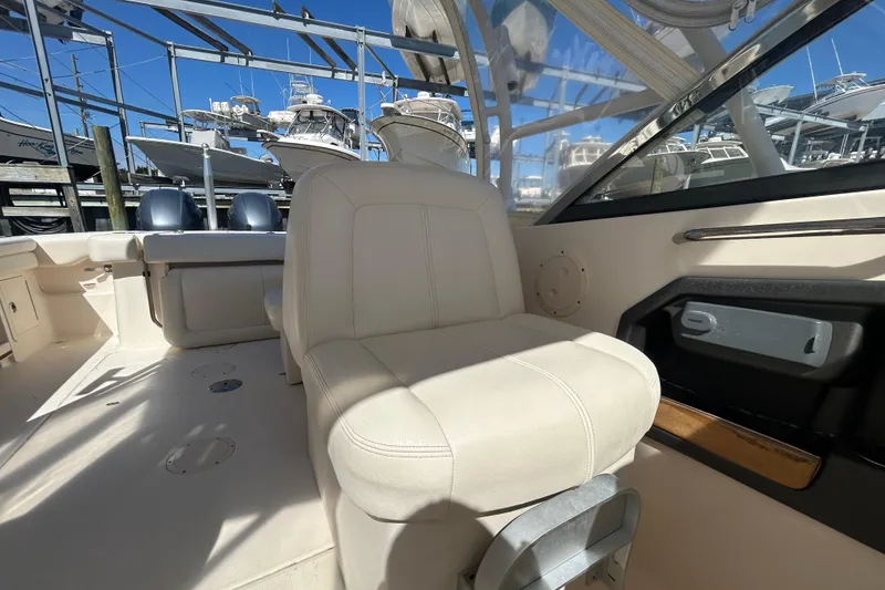 Slide: The Image of 2015 Grady-White Freedom 275 boat interior with seating and controls. - 14
