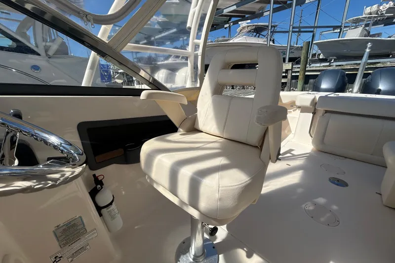 Slide: The Image of Interior of 2015 Grady-White Freedom 275 boat with helm seat and steering wheel. - 15