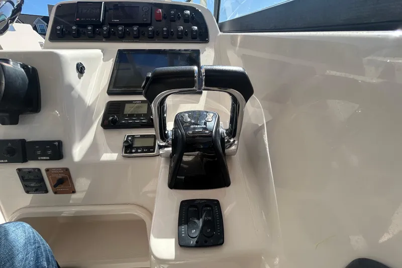 Slide: The Image of Control panel of a 2015 Grady-White Freedom 275 boat with Yamaha throttle. - 17