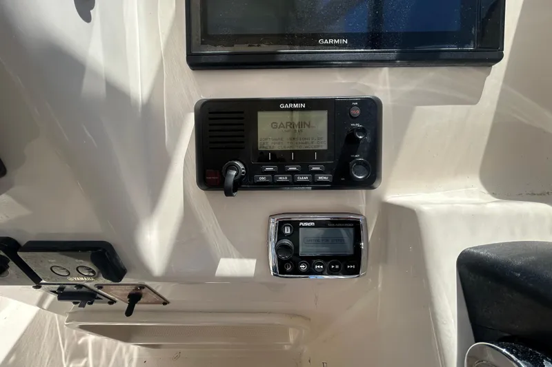 Slide: The Image of Garmin and Fusion marine electronics on 2015 Grady-White Freedom 275 boat dashboard. - 18