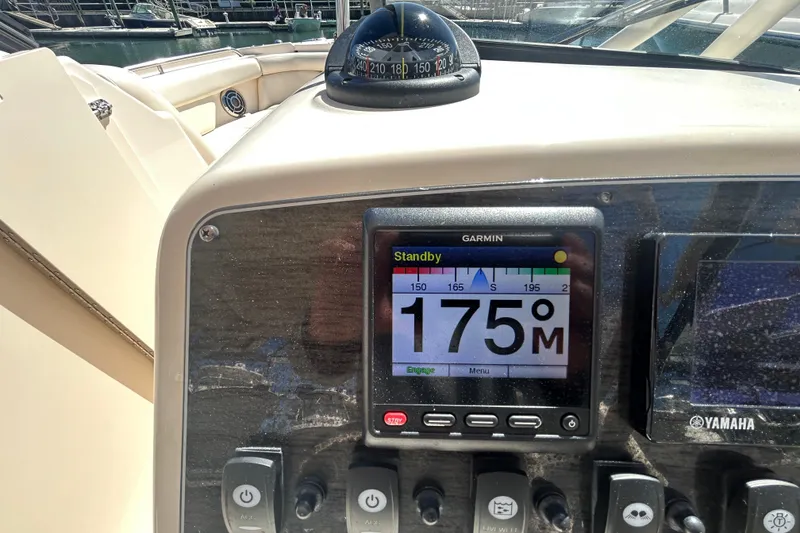 Slide: The Image of Dashboard of a 2015 Grady-White Freedom 275 boat with Garmin navigation display. - 21