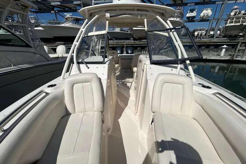 Slide: The Image of 2015 Grady-White Freedom 275 boat interior with white seating and windshield. - 29