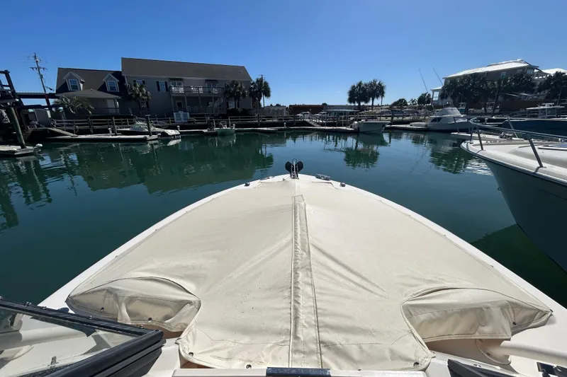 Slide: The Image of 2015 Grady-White Freedom 275 boat docked in a serene marina setting. - 33