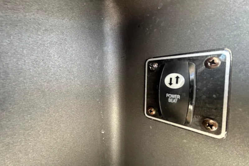 Slide: The Image of Power seat switch on 2015 Grady-White Freedom 275 boat interior. - 36