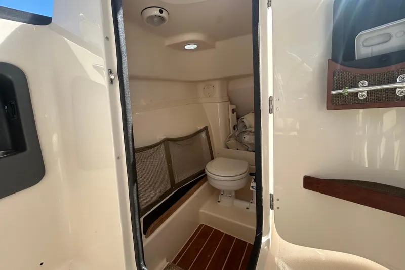 Slide: The Image of Interior view of 2015 Grady-White Freedom 275 boat bathroom with toilet and storage. - 37