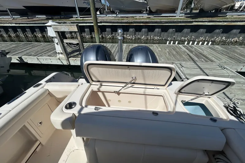 Slide: The Image of 2015 Grady-White Freedom 275 boat with open storage compartments at dock. - 8