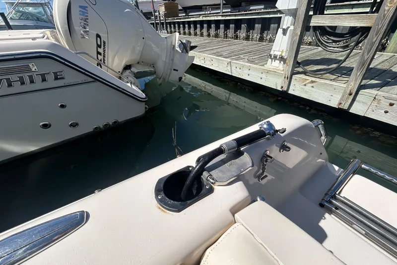 Slide: The Image of 2015 Grady-White Freedom 275 boat docked, featuring Yamaha outboard motor. - 9
