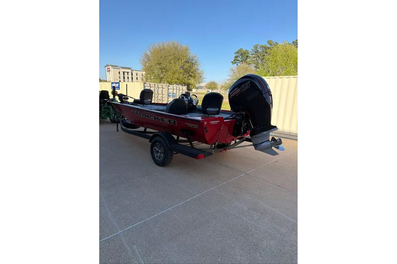 Slide: The Image of 2026 Tracker Pro Team 195 boat on trailer, parked outdoors under clear sky. - 5