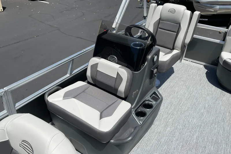 Slide: The Image of 2026 Sun Tracker Bass Buggy 16 XL Select interior with gray seating and steering console. - 9