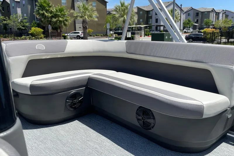 Slide: The Image of 2026 Sun Tracker Bass Buggy 16 XL Select interior with gray seating and speaker system. - 25