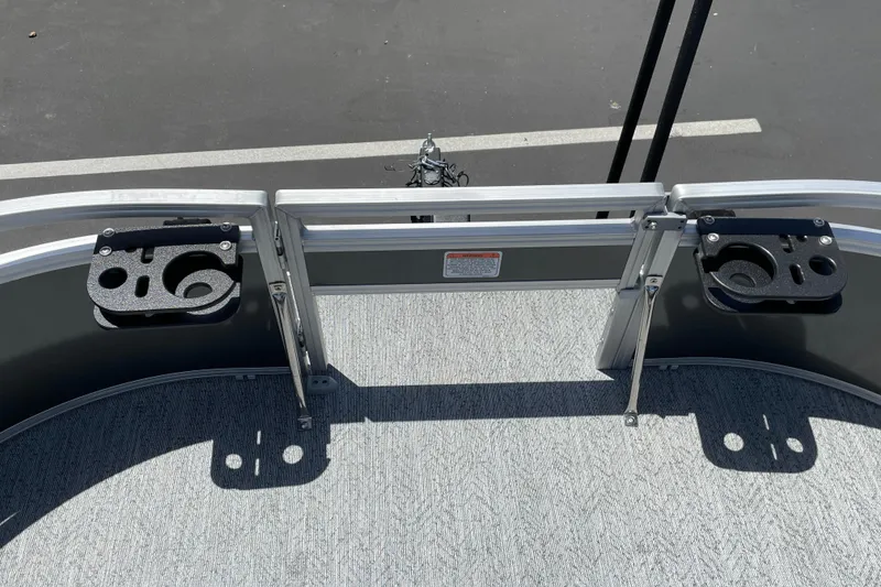 Slide: The Image of 2026 Sun Tracker Bass Buggy 16 XL Select boat deck with cup holders and railing. - 19