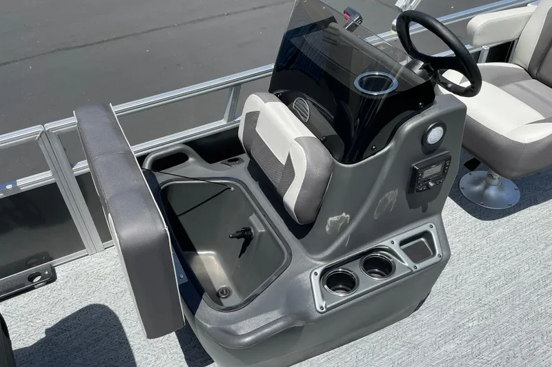 Slide: The Image of 2026 Sun Tracker Bass Buggy 16 XL Select boat console with storage and cup holders. - 16