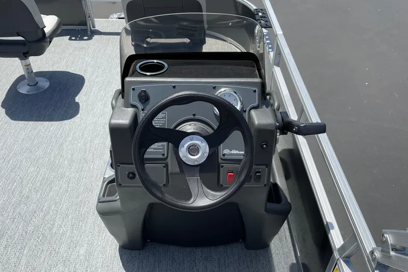 Slide: The Image of 2026 Sun Tracker Bass Buggy 16 XL Select steering console with gauges and controls. - 11