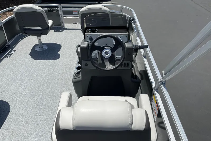 Slide: The Image of 2026 Sun Tracker Bass Buggy 16 XL Select boat interior with steering console and seating. - 12