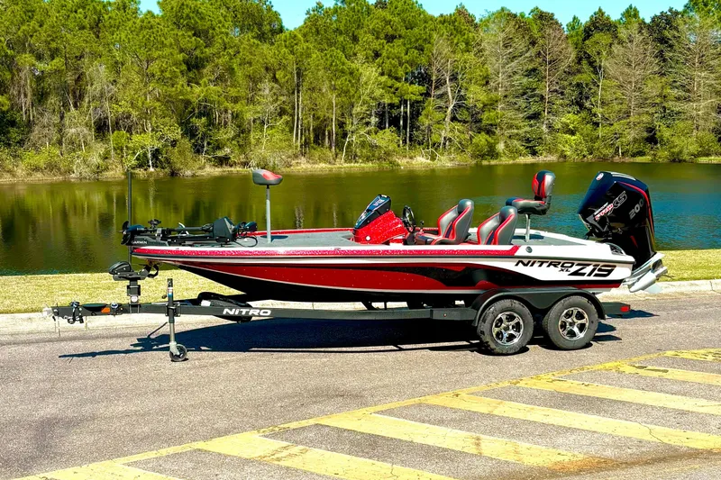 The Image of 2026 Nitro Z19 XL Pro boat on trailer by a scenic lake. - 0
