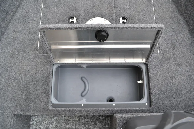 Slide: The Image of Open storage compartment in 2026 Tracker Pro 170 boat, featuring gray interior and carpeted exterior. - 61