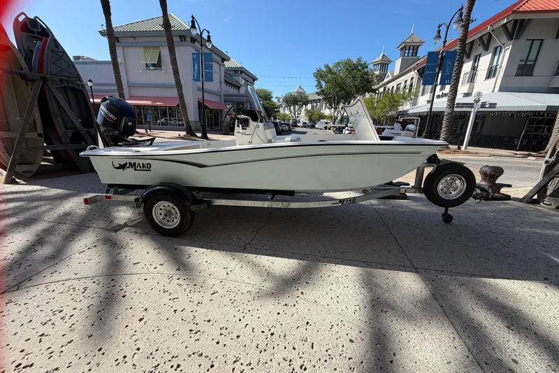 The Image of 2026 Mako Pro Skiff 15 CC boat on trailer in urban setting. - 0