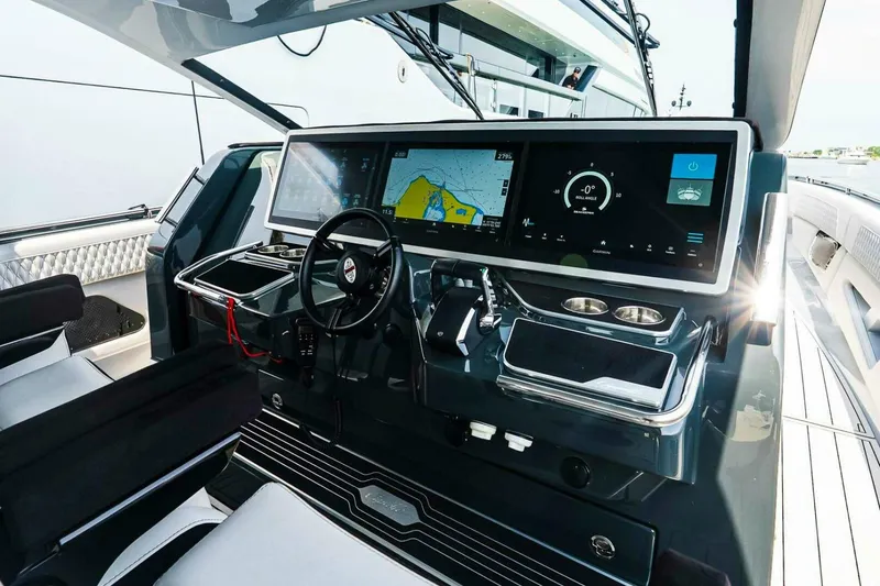 Slide: The Image of Helm of 2025 Cigarette 52' Thunder yacht with advanced navigation displays and controls. - 24