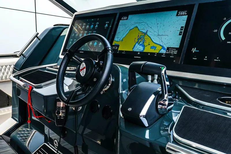 Slide: The Image of Helm of 2025 Cigarette 52' Thunder with advanced navigation displays and controls. - 26