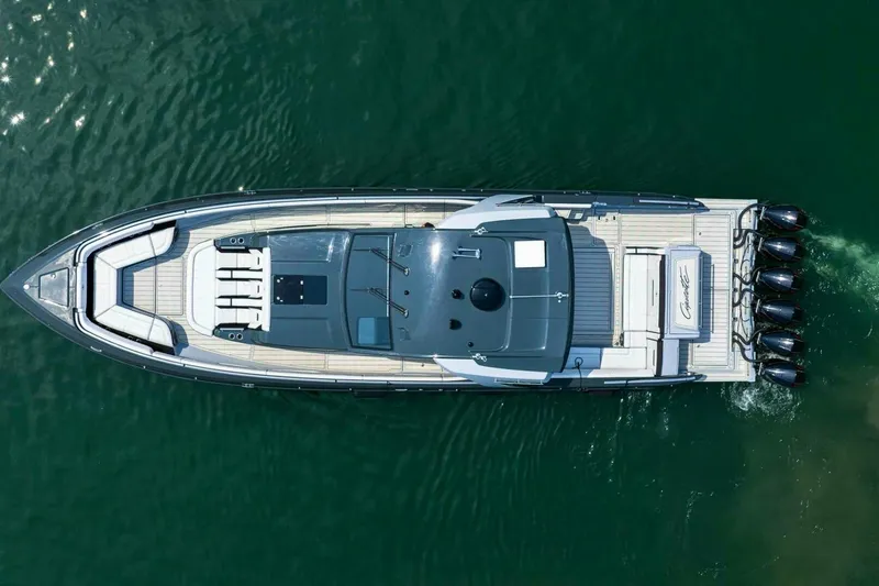 Slide: The Image of Top view of 2025 Cigarette 52' Thunder boat on water, showcasing sleek design and powerful engines. - 3