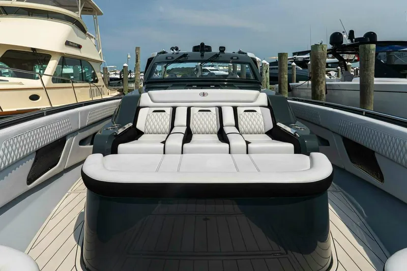 Slide: The Image of 2025 Cigarette 52' Thunder luxury yacht interior with plush seating at marina. - 33