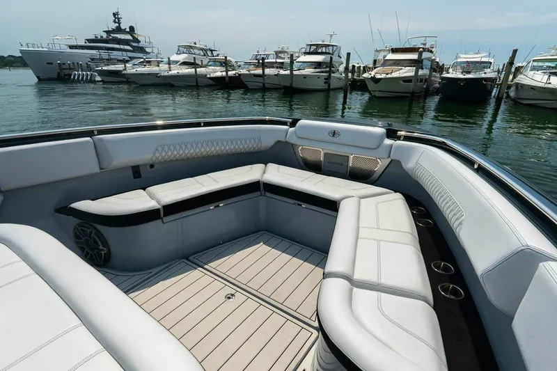 Slide: The Image of Luxurious seating area on a 2025 Cigarette 52' Thunder boat docked at a marina. - 34