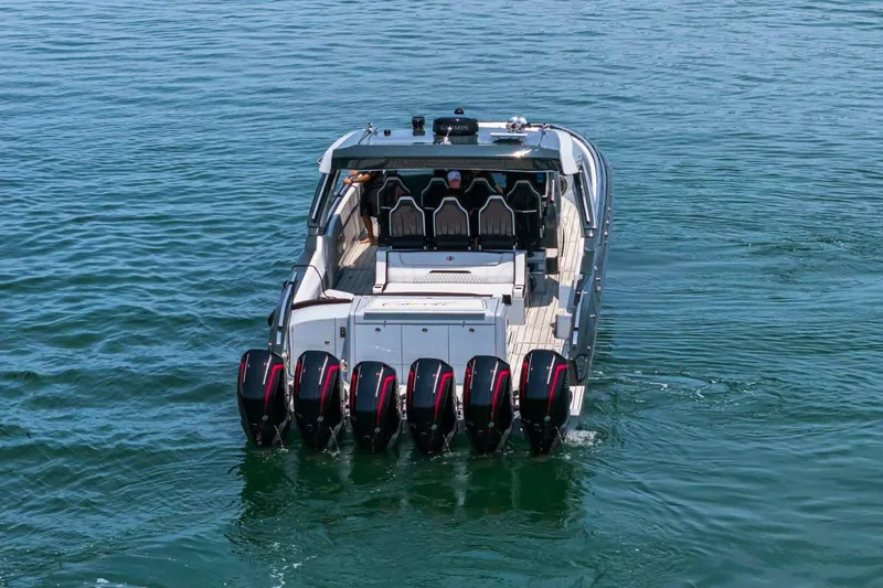 Slide: The Image of 2025 Cigarette 52' Thunder boat with six powerful outboard engines on water. - 4