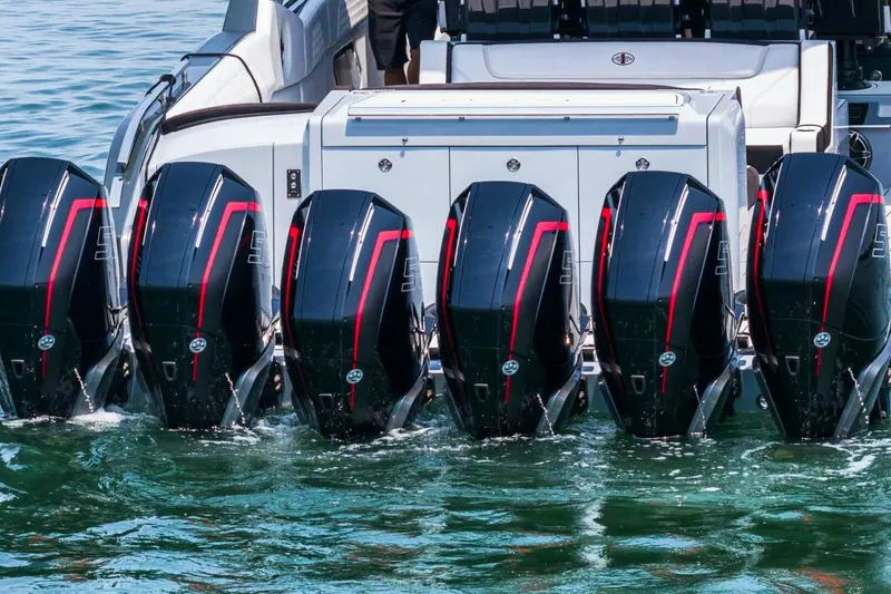 Slide: The Image of Powerful outboard engines on a 2025 Cigarette 52' Thunder boat in water. - 5