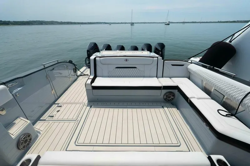 Slide: The Image of Luxurious 2025 Cigarette 52' Thunder yacht deck with sleek seating and powerful engines. - 8