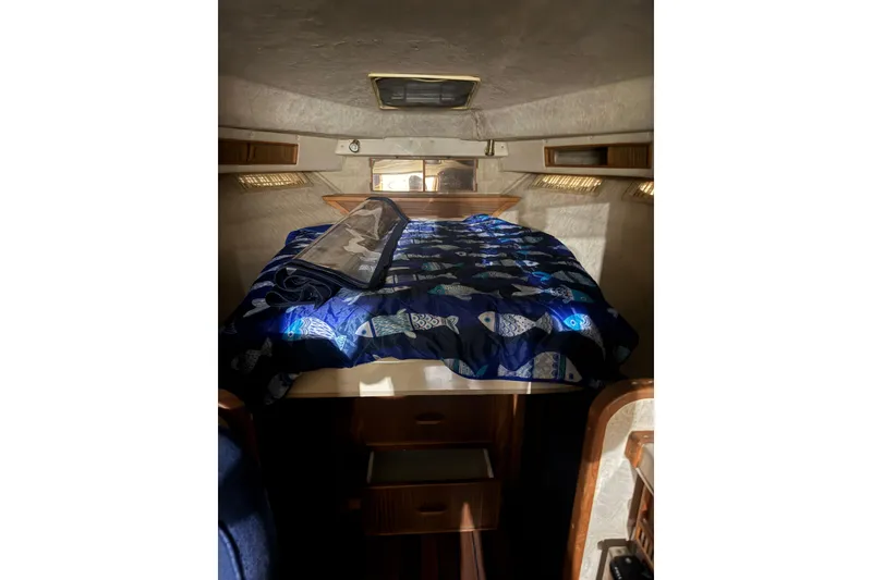 Slide: The Image of Interior cabin of 1986 Sea Ray 340 Express Cruiser with bed and storage. - 16