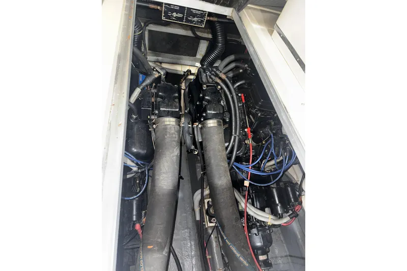 Slide: The Image of Engine compartment of a 1986 Sea Ray 340 Express Cruiser with visible hoses and wiring. - 5