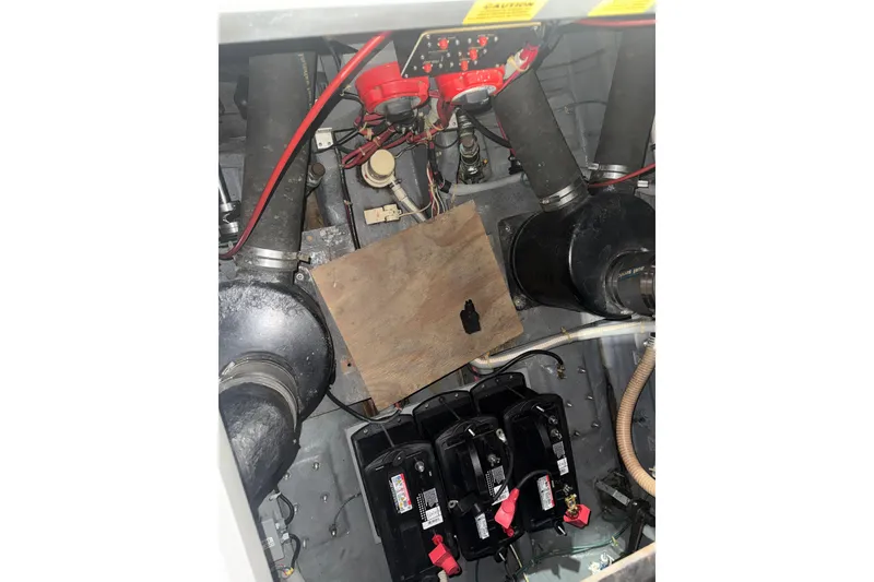 Slide: The Image of Engine compartment of 1986 Sea Ray 340 Express Cruiser with visible components and wiring. - 6