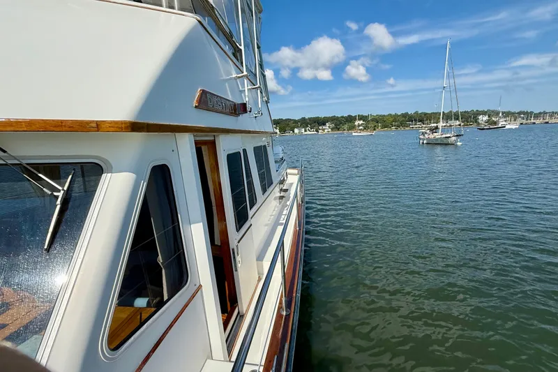 Slide: The Image of 1997 Sabre Sabreline 47 yacht on calm water with sailboats in the background. - 21