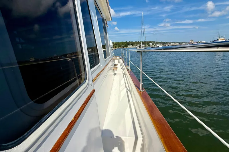 Slide: The Image of Side view of 1997 Sabre Sabreline 47 yacht on calm water under blue sky. - 24