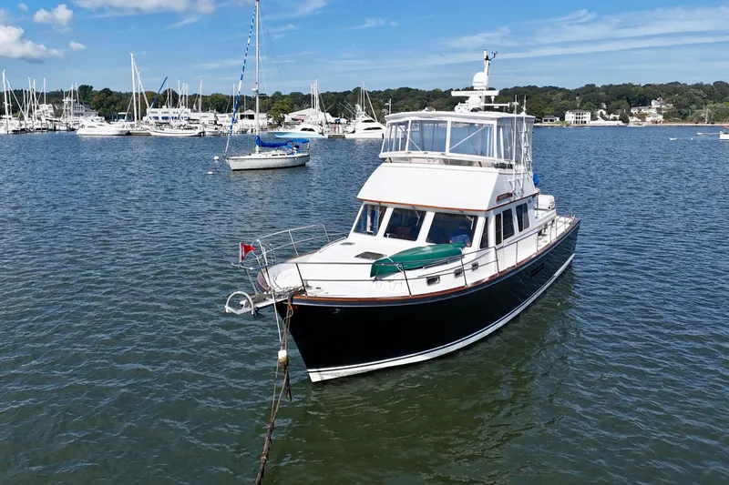 Slide: The Image of 1997 Sabre Sabreline 47 yacht anchored in a scenic marina with sailboats. - 3
