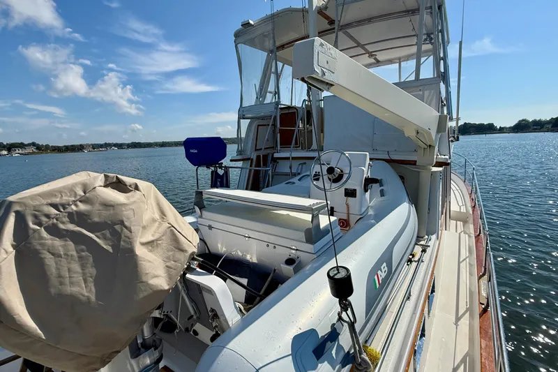 Slide: The Image of 1997 Sabre Sabreline 47 yacht with dinghy on deck, moored on a sunny day. - 30